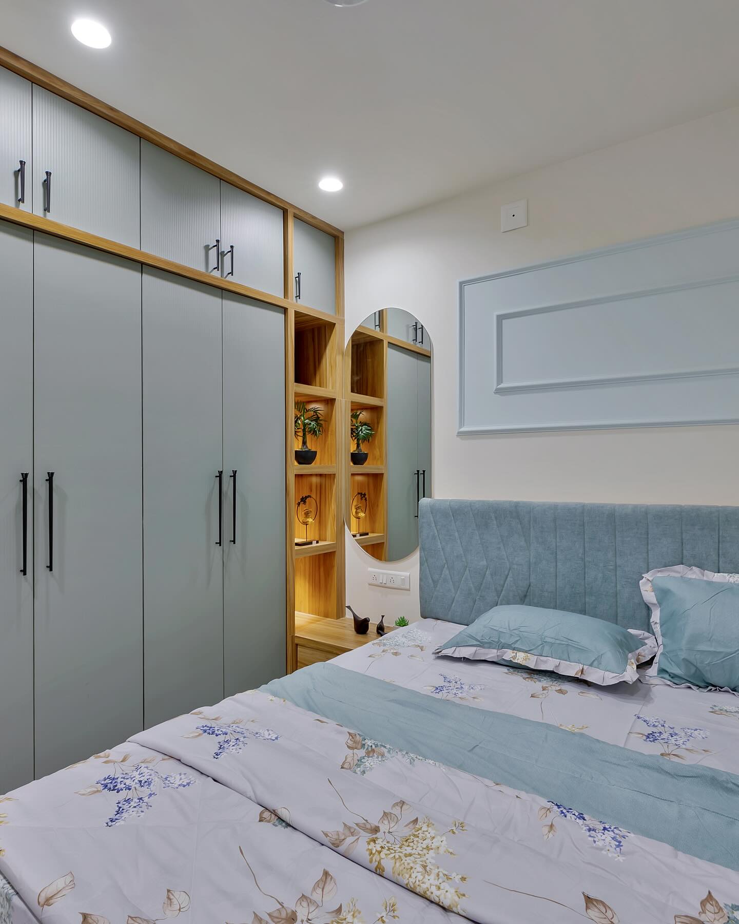 Bedroom with arched mirror and mint wardrobe