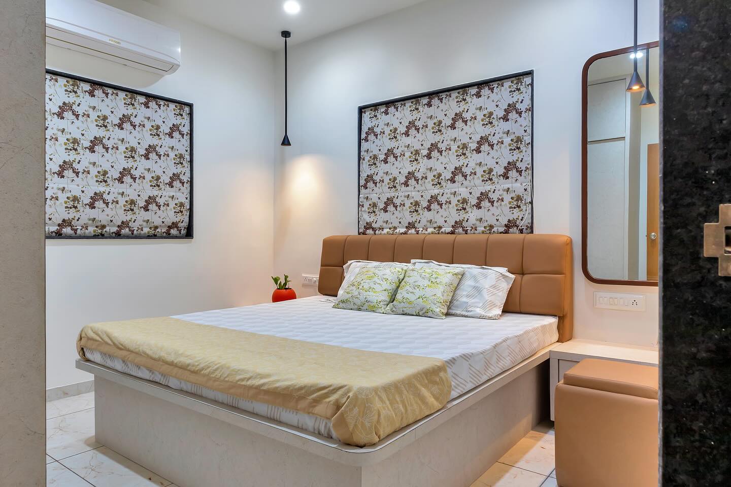 Bedroom with floral wallpaper and leather headboard
