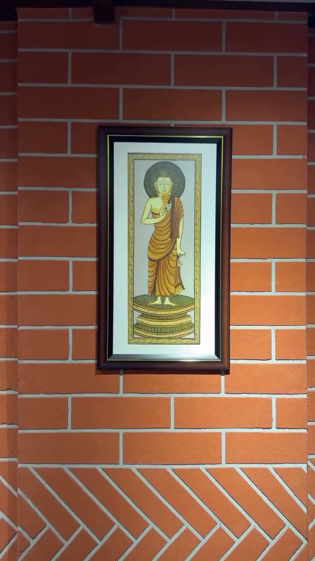Ayurveda clinic with framed Buddha art on exposed brick