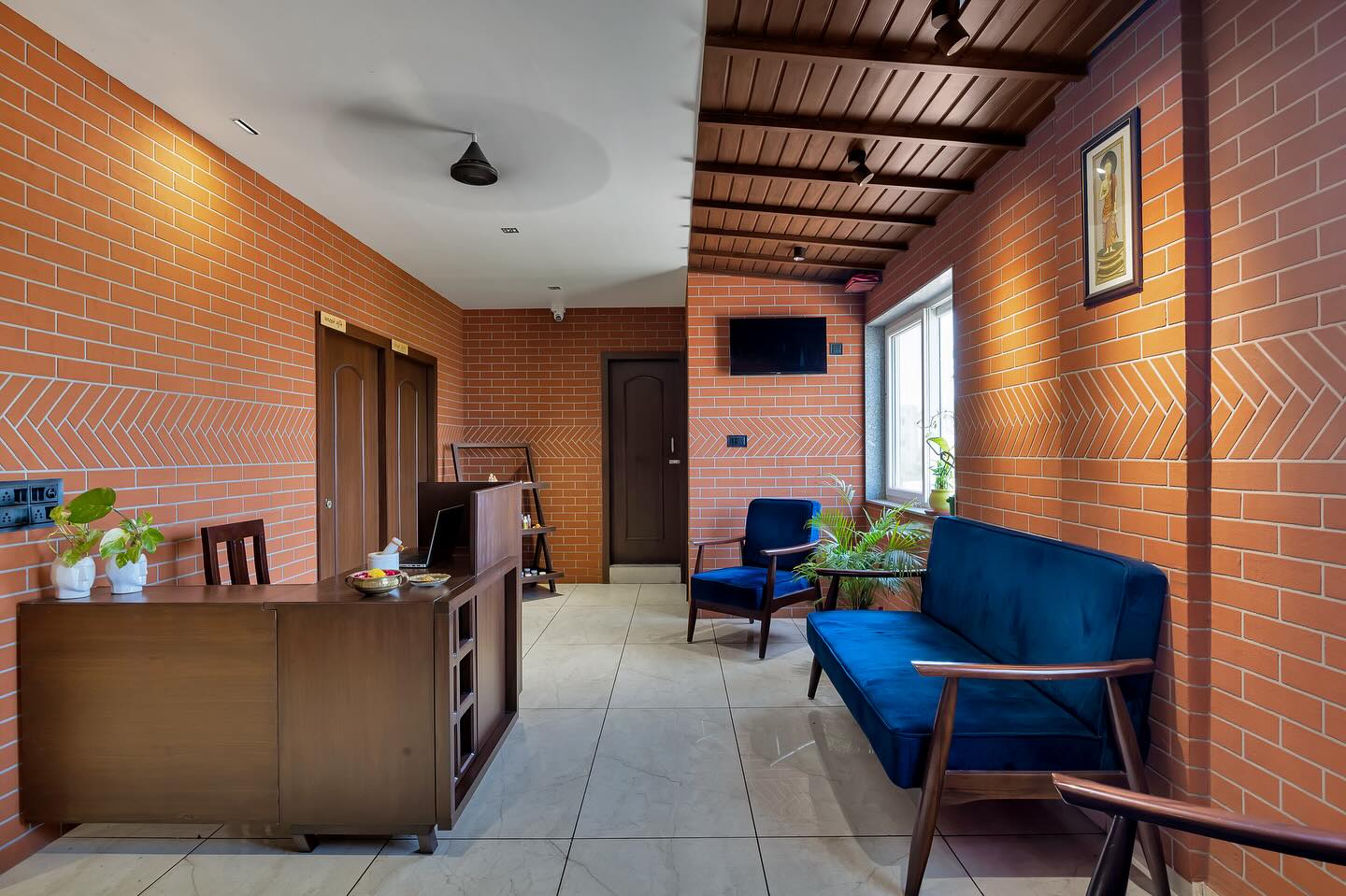 Family lounge with brick red wall and blue sofa