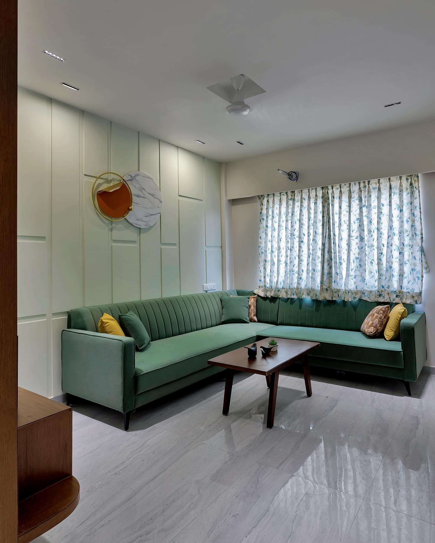 Living room with sage sofa and panelled walls